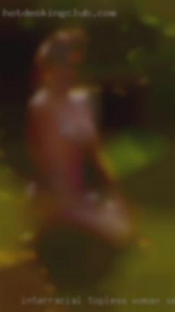 Interracial topless woman sex threesome.